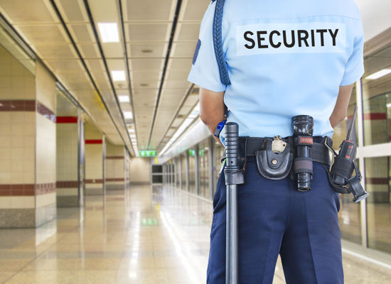 rear view of security person in an empty building