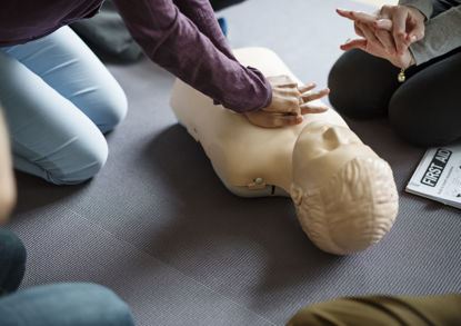 person using a dummy for CPR training